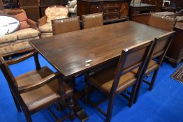 An early 20th Century oak refectory style dining table and set of six (four plus two) leather