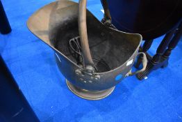 A traditional brass coal helmet , sold with pair of unmatched tongs