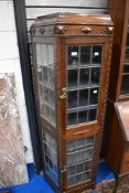 A late 19th or early 20th Century oak end display with leaded glass doors, height approx 163cm