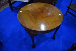 An early to mid 20th Century coffee table having circular top and cabriole legs having ball and claw