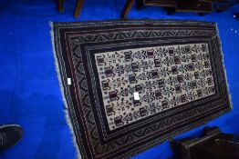 A Persian style rug in shades of brown and burgundy, approx. 154 x 91cm