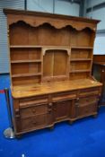 A Victorian and later pine dresser , having cupboard base and open delft rack, approx dimensions
