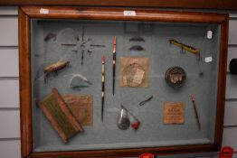 A vintage framed display of fishing tackle 58cm x 48cm