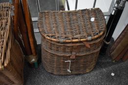 A vintage wicker fishing creel measuring 30cm high 34cm wide and 23cm deep