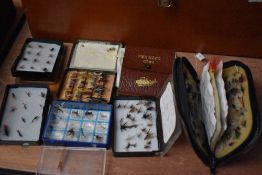 A small selection of pocket fly boxes and wallets containing salmon and trout flies