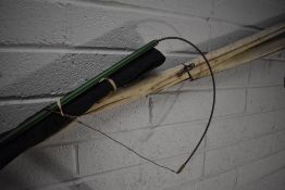 Two vintage fishing rods and a tail snare for landing, one wooden handled and fibreglass beech