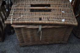 A wicker basket containing general fishing tackle including priest floats,hooks etc