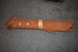 A collection of pieces of tan leather, for crafts and projects.