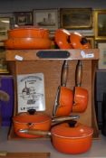 A Le Creuset pan rack and a selection of saucepans, frying pan etc.
