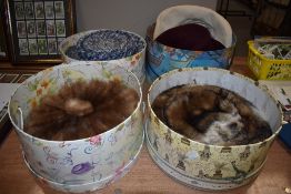 Three hat boxes and a variety of vintage and retro hats, including mink.