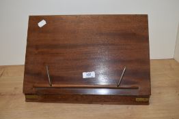A vintage mahogany book rest with brass fittings.
