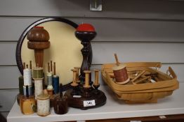 Two vintage bobbin/spool holders, a trug of threads and spools, tape measures and a foot stool to