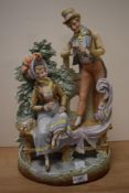 A 19th Century continental bisque porcelain figure group of a courting couple, the rear impressed