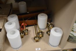 Two mid century lights, each having three stems on wooden plinth with six glass shades.