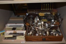 A vintage oak canteen containing mixed cutlery, including bone handled, two candle sticks, two boxes