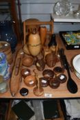 A selection of treen, including turned ornaments, lidded pots of ribbed form, shuttle, spoons etc.