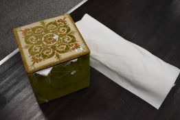 A vintage sewing box cum stool, having padded inner lid, containing lining fabrics.