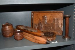 A selection of treeen, including bobbin shuttles, carved lidded pots and carved decorative scenes.