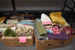 A large collection of cushion covers, various colours, styles and sizes.