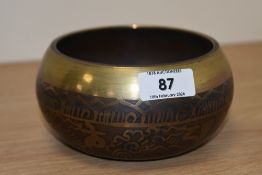 A machine made brass Tibetan Buddhist singing bowl.