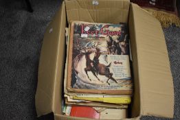 A box full of vintage sheet music and music scores.