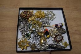 An assorted collection of costume jewellery, to include an early 20th Century gilt metal military
