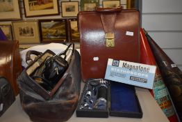 A vintage doctors leather Gladstone bag, a brief case and a selection of medical equipment,