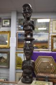 A carved hardwood tribal study depicting two figures on top of each other.