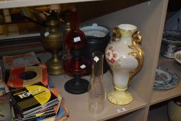 Three 19th/20th Century oil lamps, including a cranberry glass lamp, with chimneys, a Duchess Art