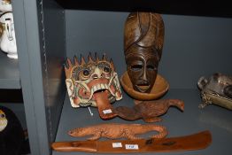 An assorted collection of African carved masks and other hardwood items