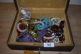 A jewellery box and an assortment of costume jewellery.