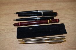 A brushed steel pencil and biro set and an assortment of pen parts.