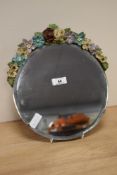 An early 20th Century Barbola bevelled mirror, measuring 26cm in diameter