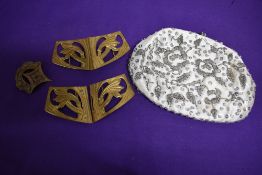 A vintage beaded evening bag and two Antique brass belt buckles.