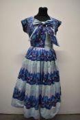 A stunning 1950s strapless cotton sun dress and matching bolero, having fun novelty abstract village