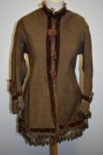 A Brown Victorian overcoat, having velvet trim, tassels to hem and sleeves and silk bow details (