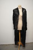 An early 20th century black overlay / cover up, having braided detail and appliqué leaves to net