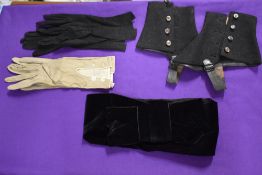 A pair of early 20th century ladies gaiters, two pairs of gloves and a velvet belt.