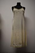 A 1930s slip having delicate floral embroidery and tulle edge.