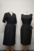 A 1950s navy blue dress, having pleats to central bodice with faux button decoration to centre,