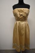 A Champagne coloured satin strapless 1950s evening dress, having Cresta label and extensive