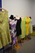 Six vintage 1960s to 1970s dresses, various styles and sizes, including full skirted mint green