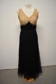 A 1930s two tone cream and black lace evening gown.