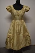 A 1950s cream silk Harvey Nichols dress, having layered skirt with integrated underskirts, gathers