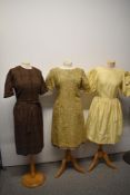 Three vintage dresses, including brown wool day dress with tie belt, buttons to sleeves and nape
