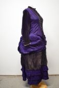 A Victorian Princess cut purple dress, using silk or silk blend textured fabric to bodice, having