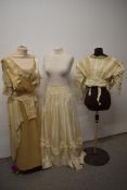 An Edwardian cream silk and crepe georgette dress, having lace to sleeves and cross over bodice, and
