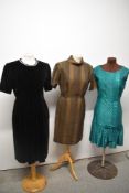 Three vintage dresses, to include 1950s black velvet dress, late 1950s green dress (zip needs