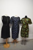 Three vintage 1960s dresses, in various colours and sizes.