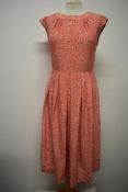 A vibrant floppy cotton 1950s day dress, having vibrant pattern and gathers to yolk.